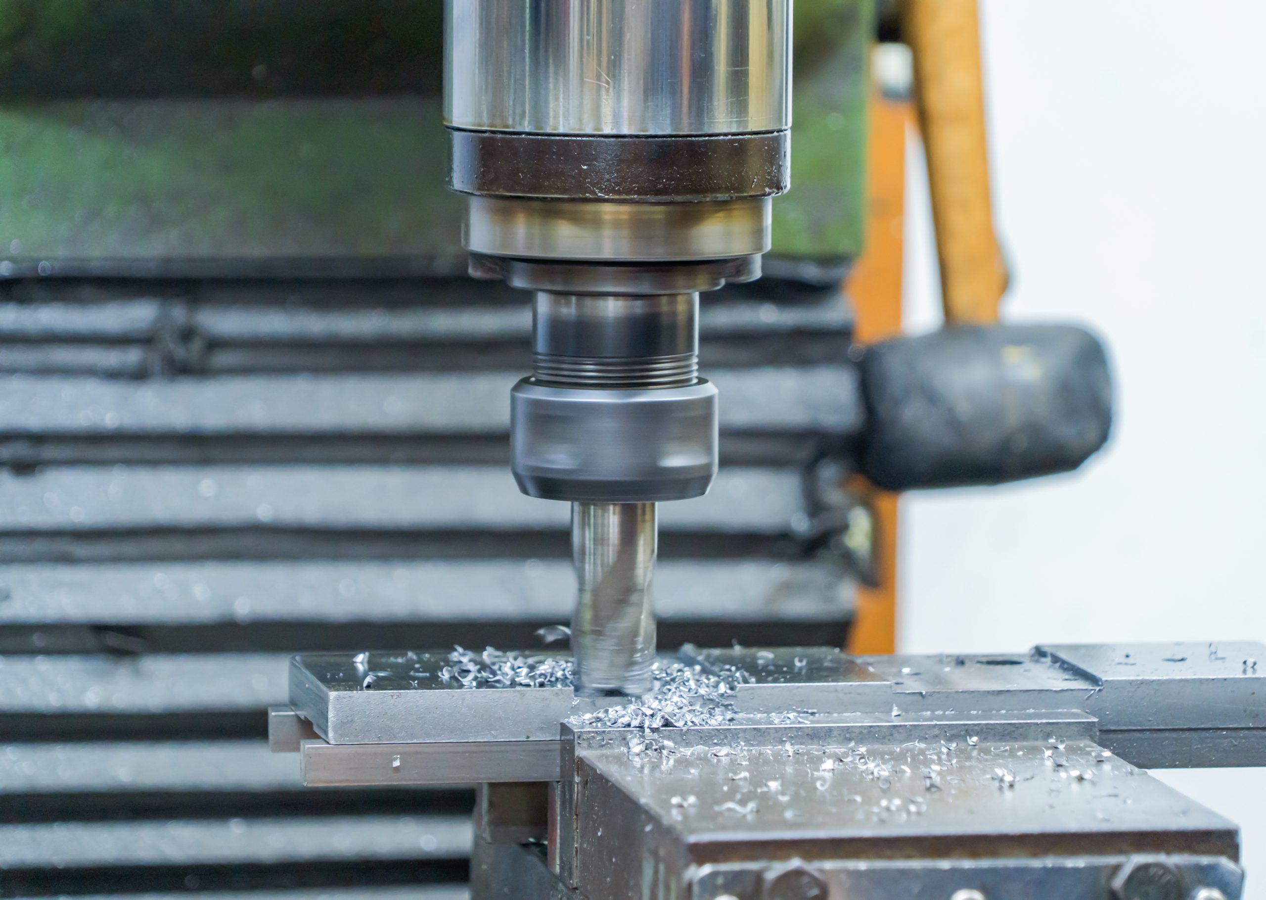 Metal fiber is rotating around big drill of steel metal lathe machine engine, technology manufacturer in operation process in industry manufacturing plant factory. Raw product equipment in warehouse.